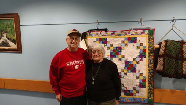 Seniors in front of Quilt at the Senior Center